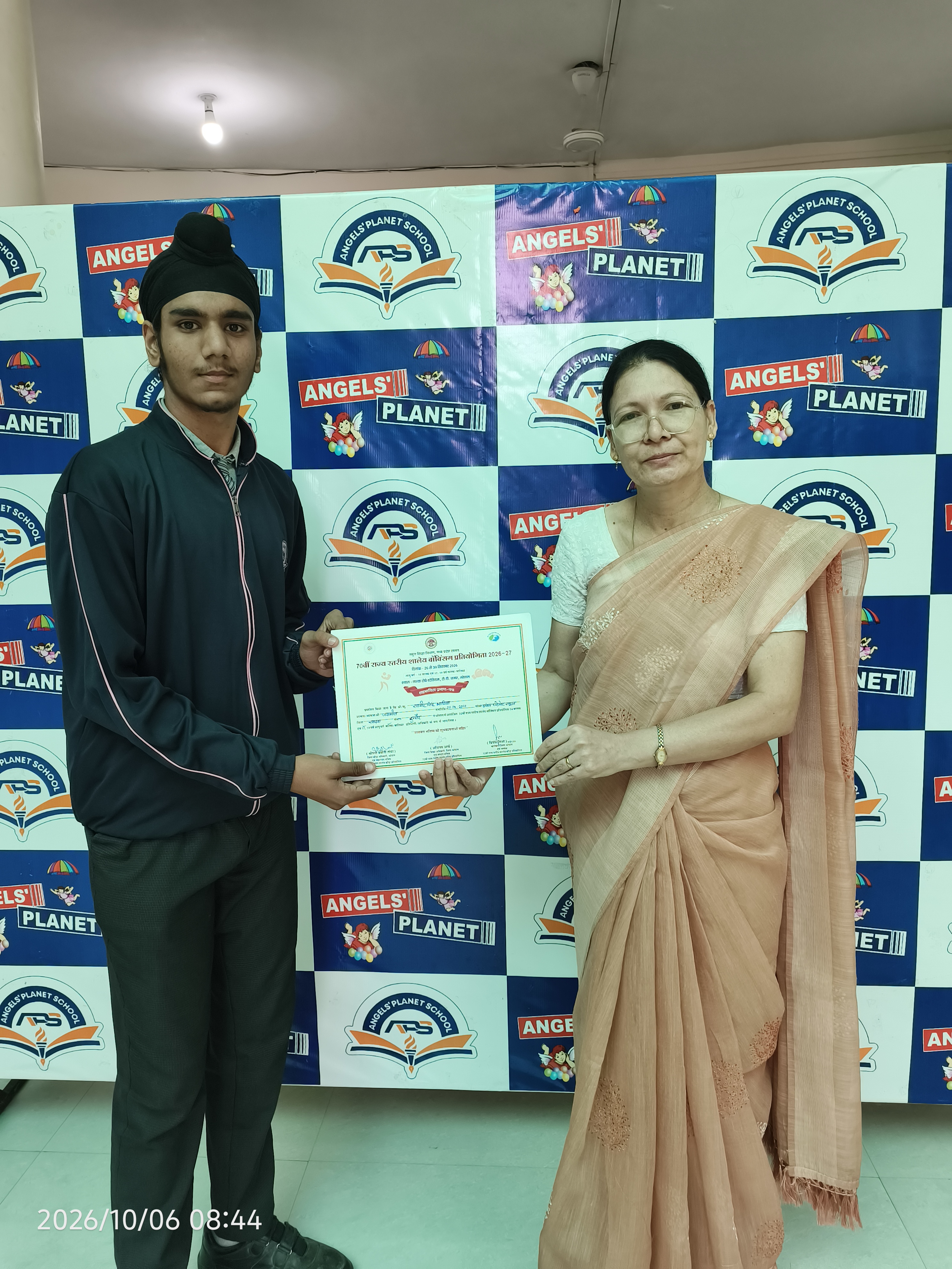 Student receiving an achievement certificate
