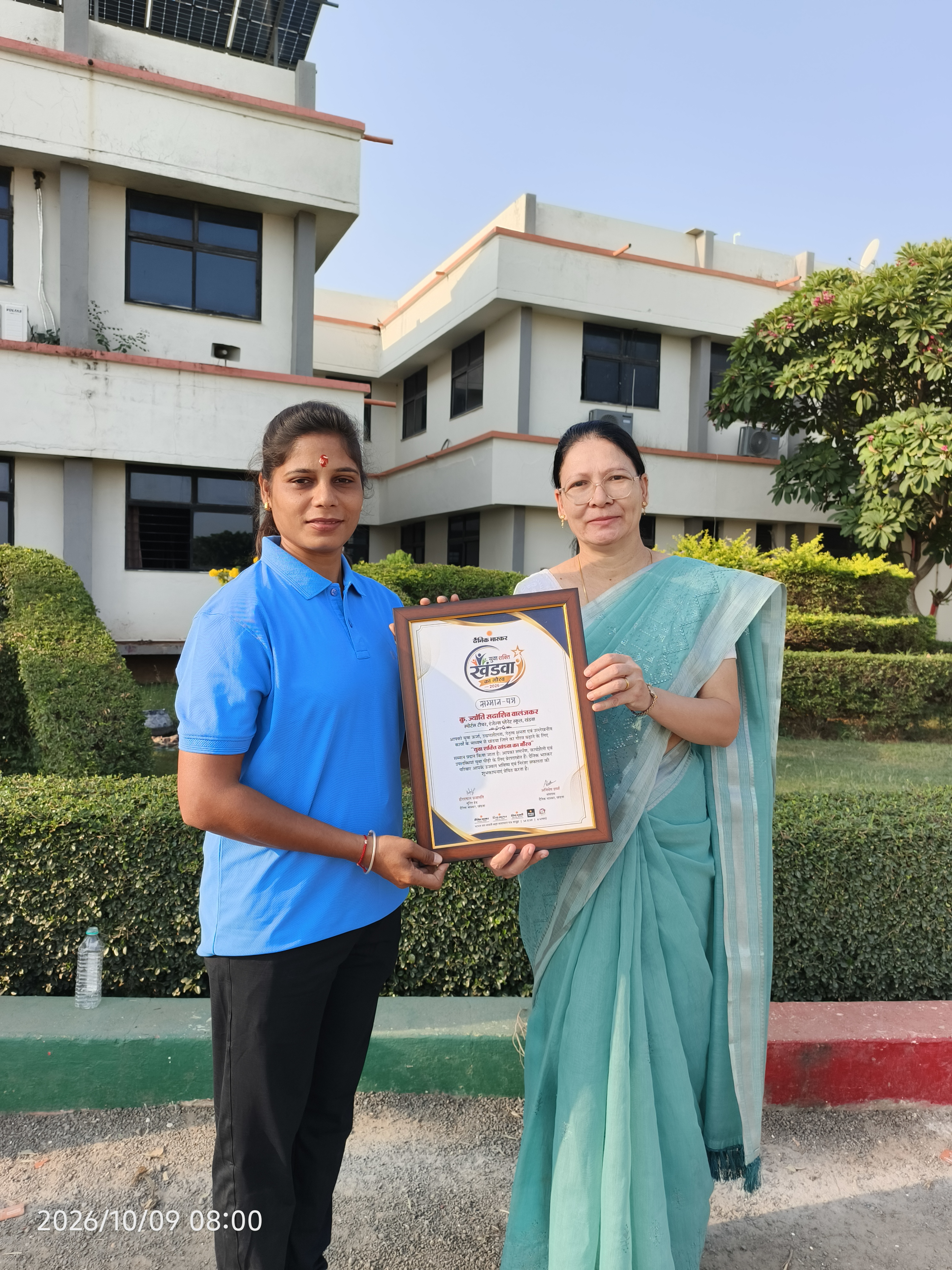 School staff presenting an award to a student