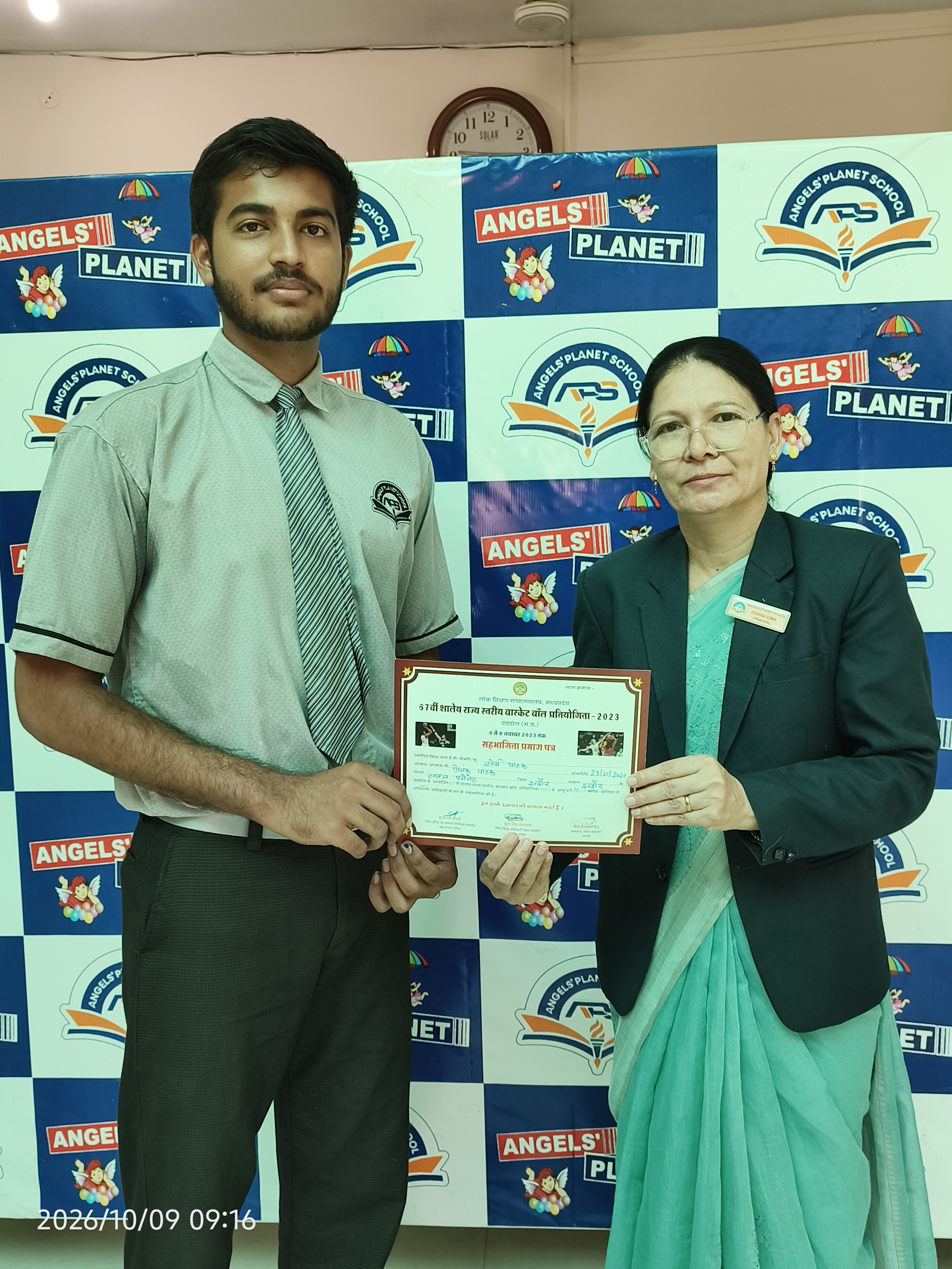 Student holding a sports achievement certificate