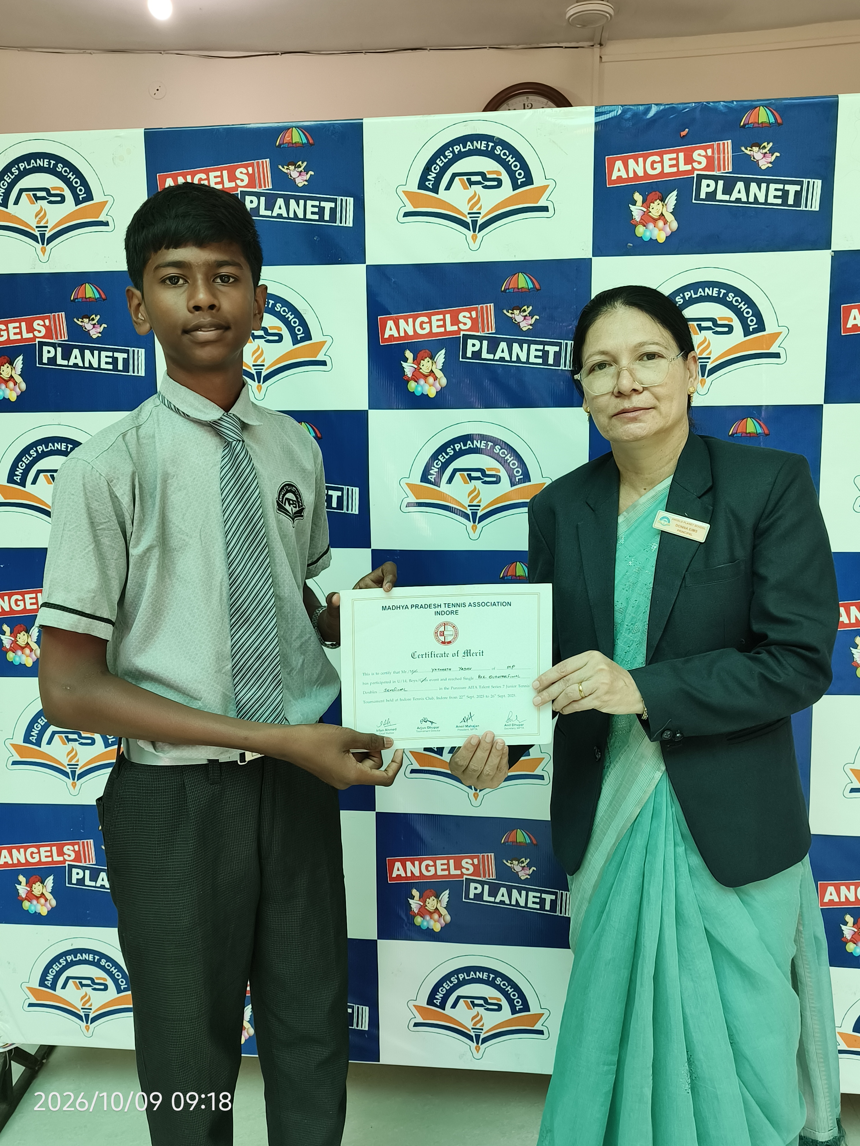 Student and teacher with an achievement certificate